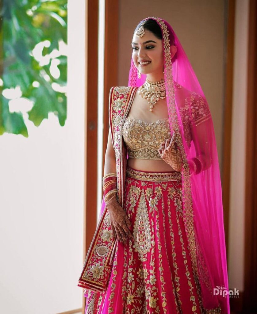 pink bridal lehenga with golden choli 