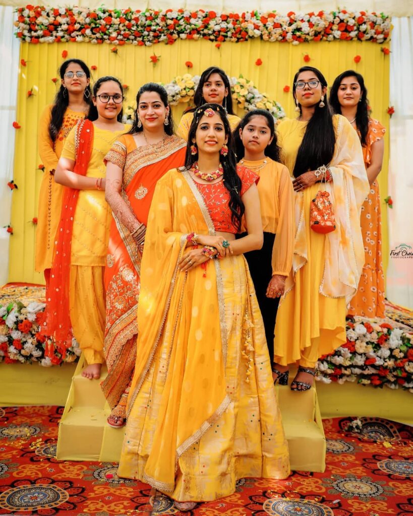 Photo of Bride with sister wearing yellow mehendi outfit