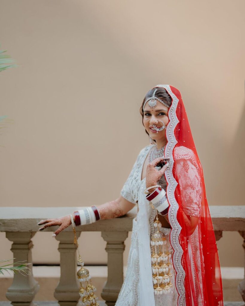 White bridal lehenga on sale with red dupatta